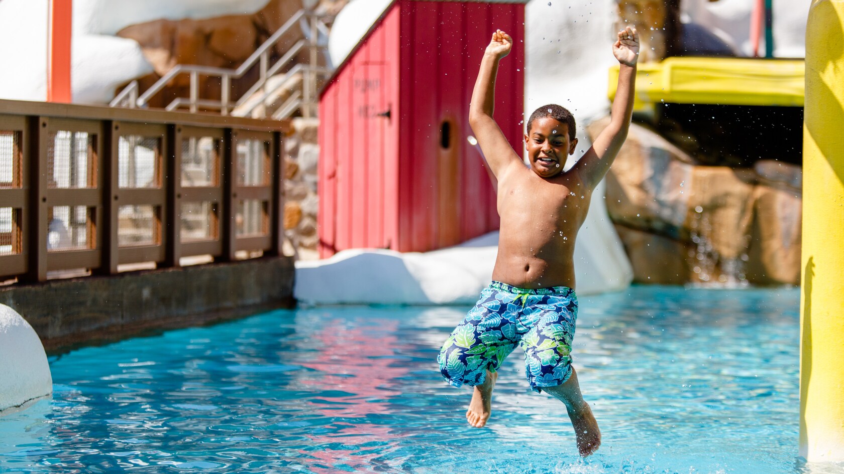 A boy dropping into the pool at Ski Patrol Training Camp's Fahrenheit Drops