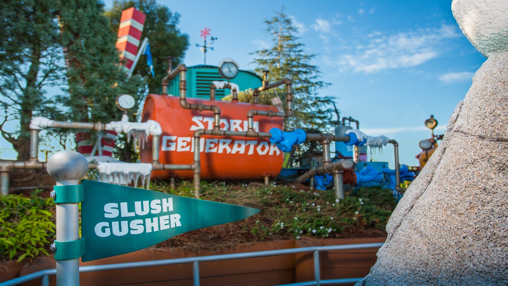 A Slush Gusher pennant-style sign with a large Storm Generator contraption behind it