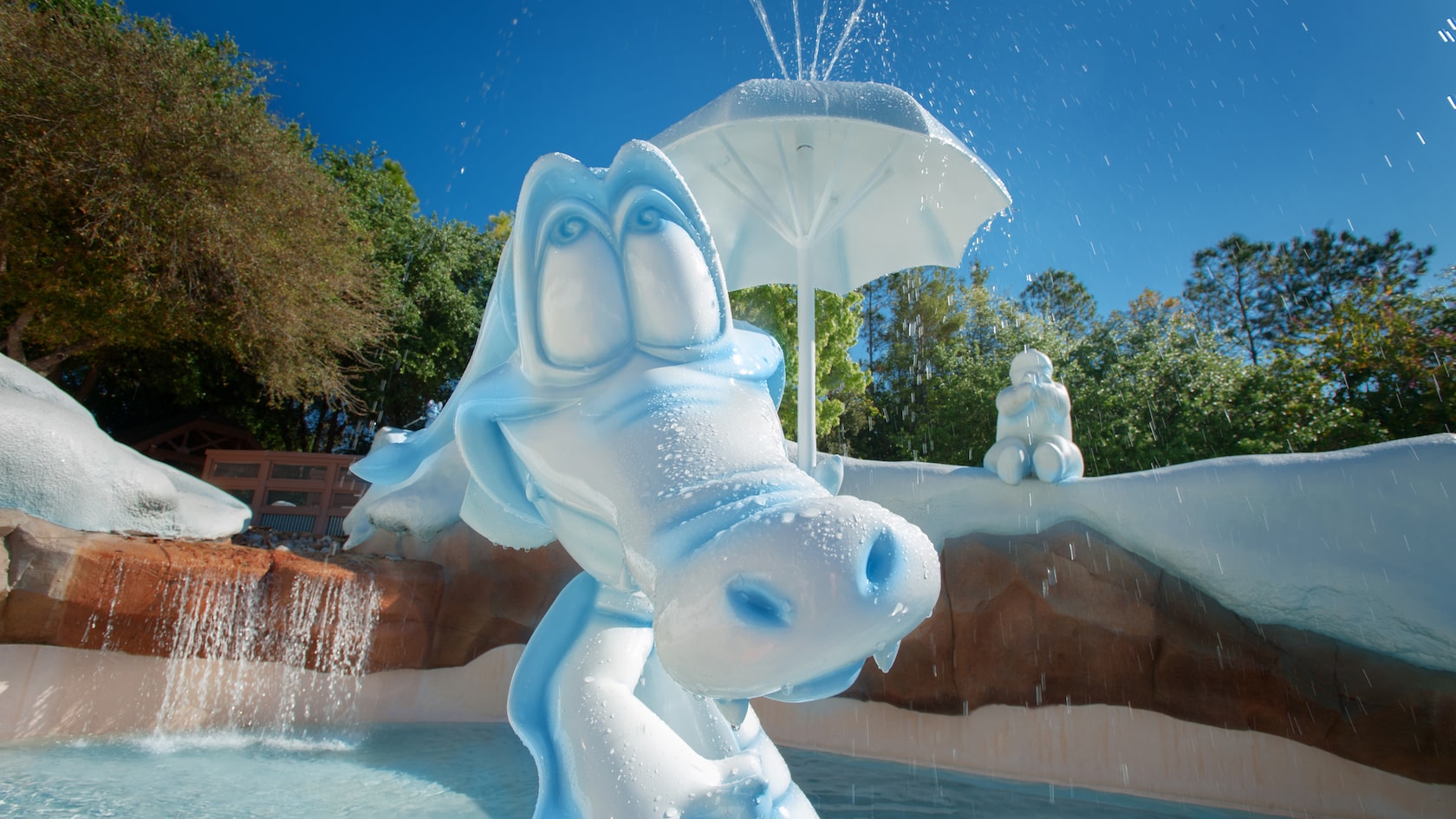 Ice Gator sculpture with water spraying from his umbrella at a Tike's Peak wading pool