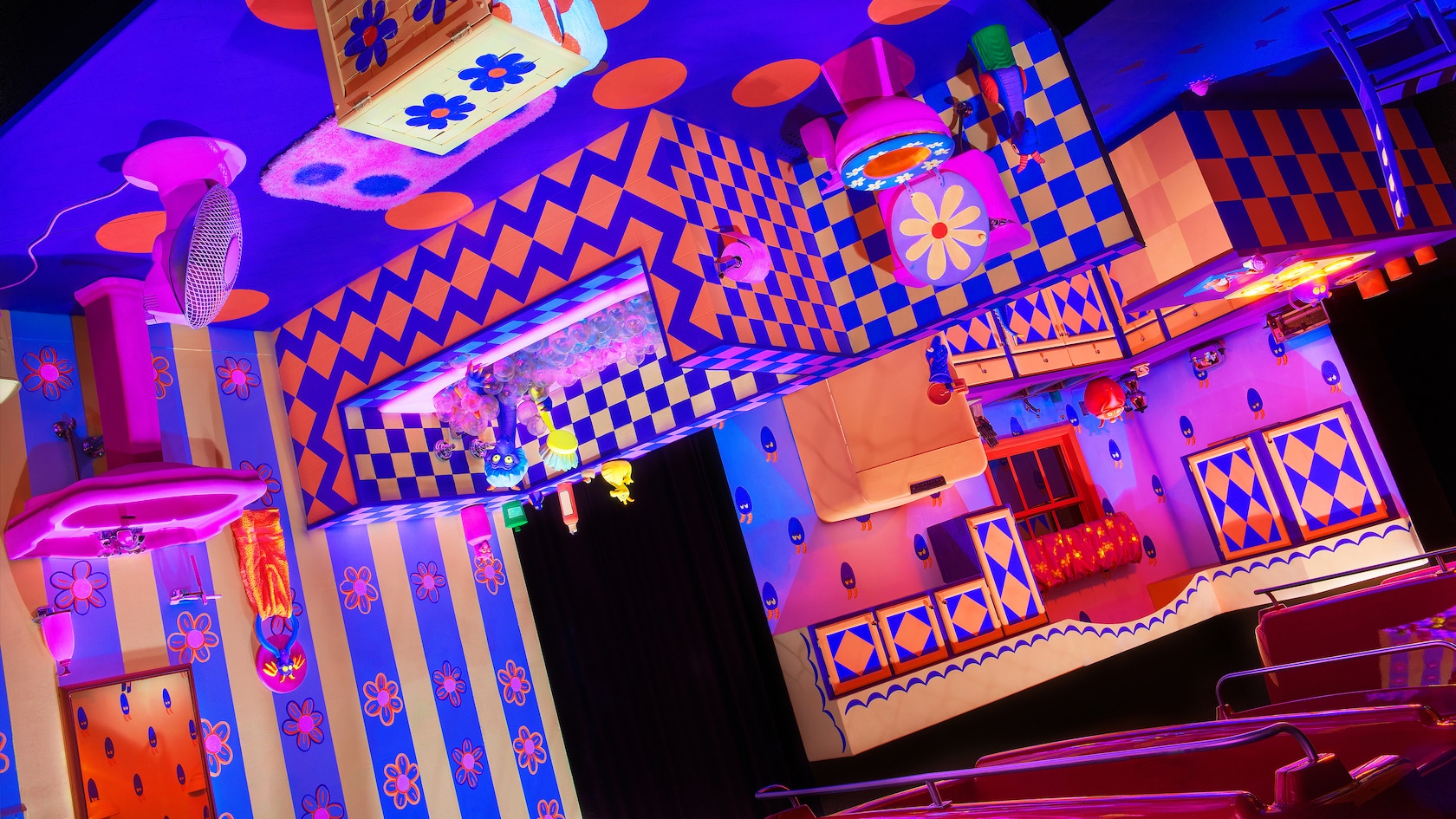 A bathroom hanging from the ceiling and designed with geometric patterns in the attraction at Epcot