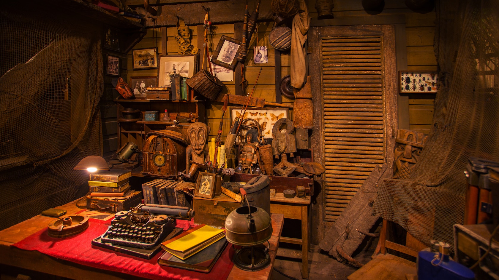 An explorer's typewriter, books and mementos on a desk in his room at the Jungle Cruise attraction