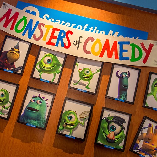 Framed pictures of the Monsters of Comedy on a wall at the Monsters, Inc. Laugh Floor attraction