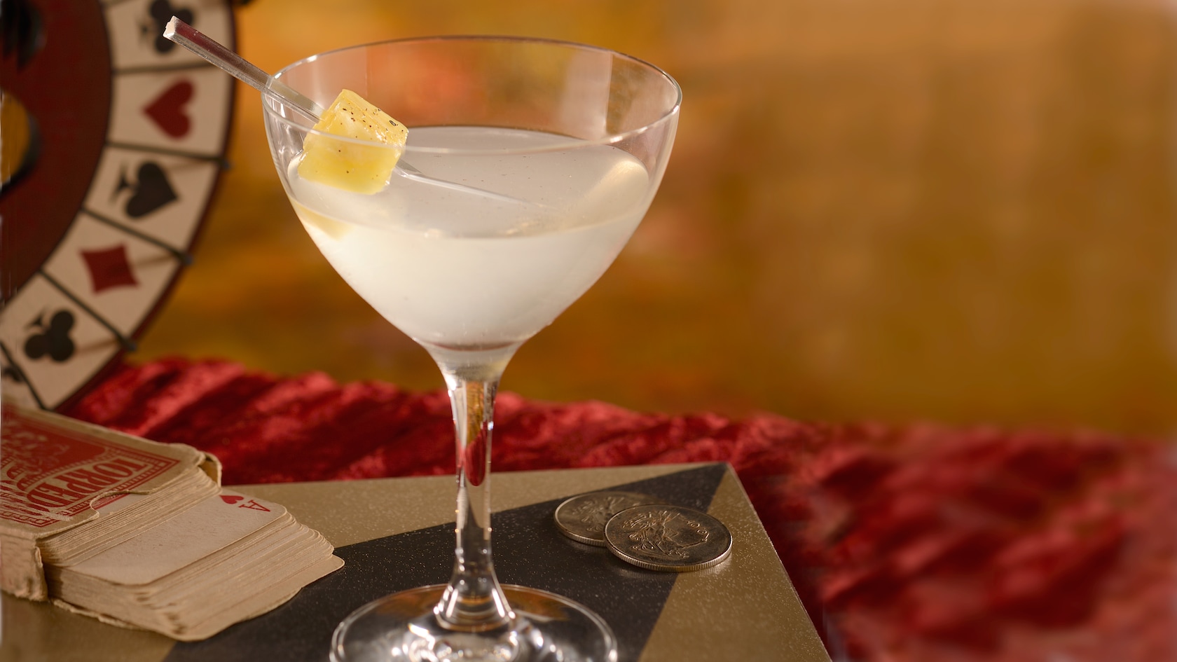 A cloudy, specialty cocktail served in a glass with a garnish of peppery pineapple at AbracadaBar