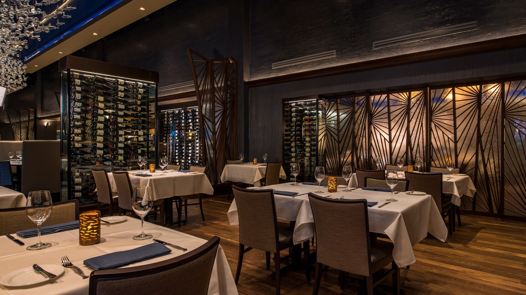 Walls of wine racks divide different areas of the dining room