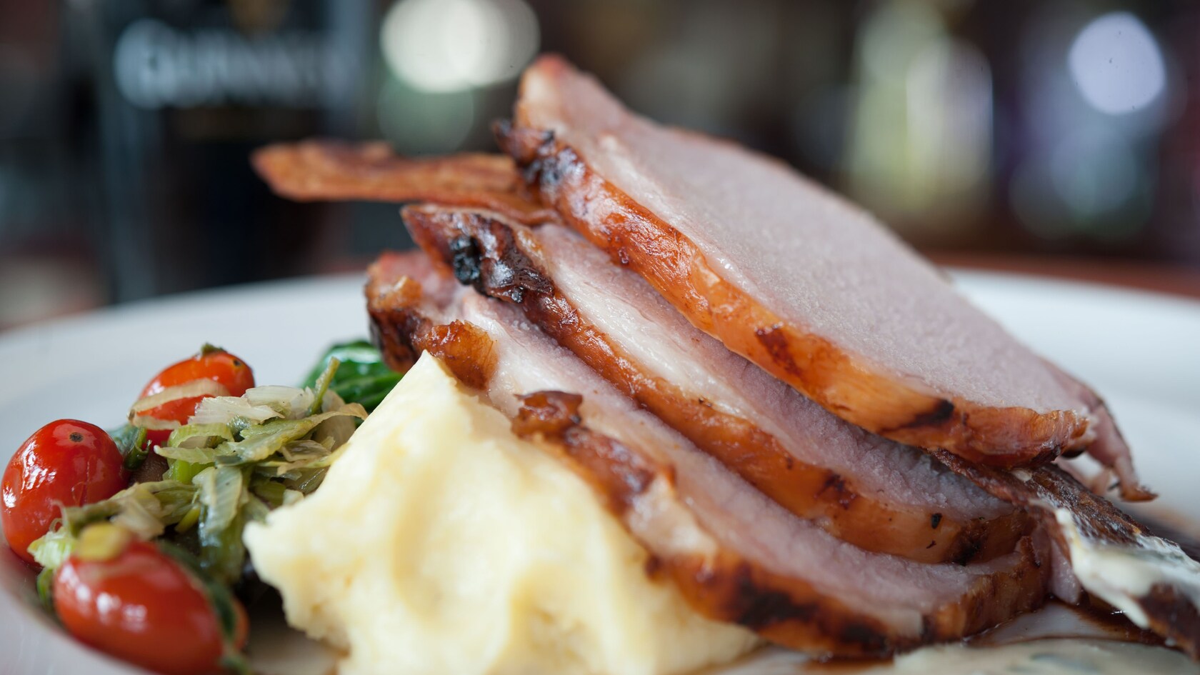 Glazed loin of bacon with braised cabbage, mashed potato and parsley cream sauce