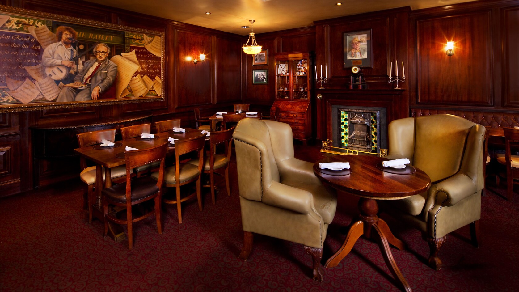 Two oversized leather armchairs and a small table in a lounge area