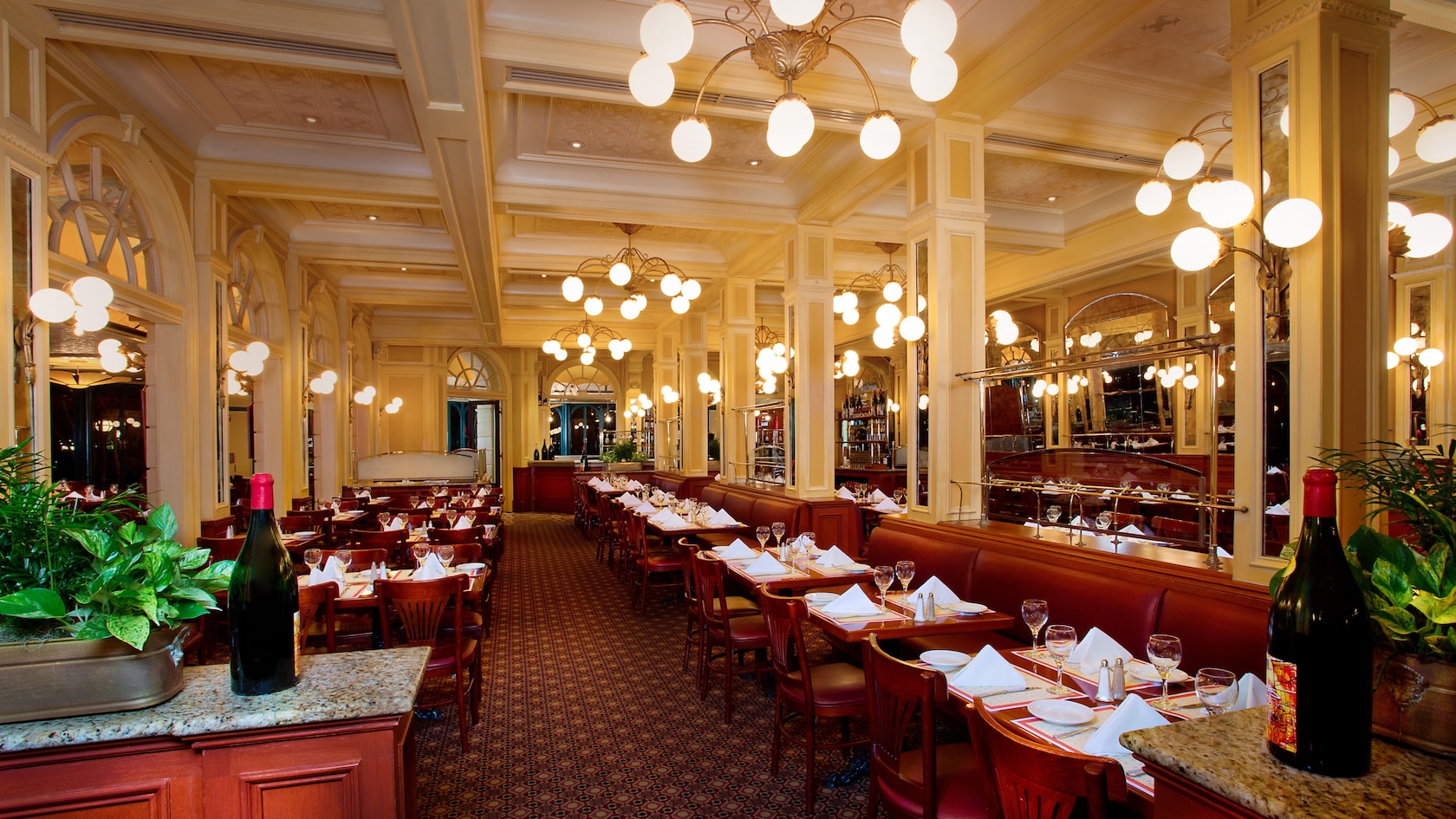 Dining area with tables set for dinner at Chefs de France in France Pavilion at EPCOT
