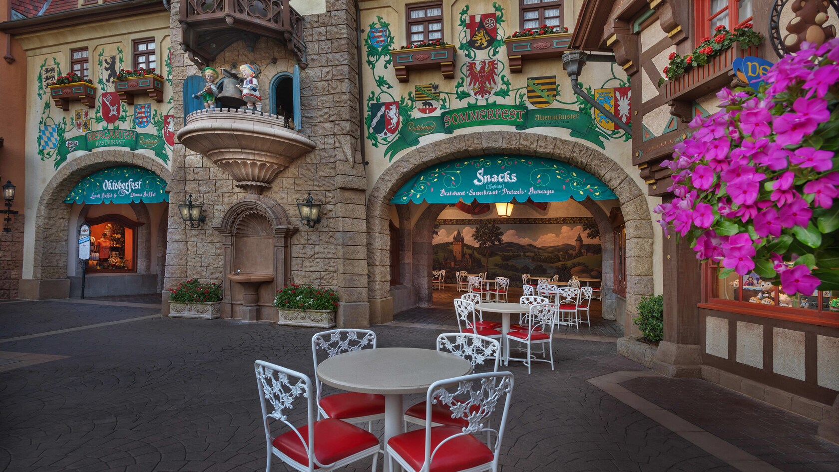 Patio tables outside the stone-arched entryway to Sommerfest in the Germany Pavilion