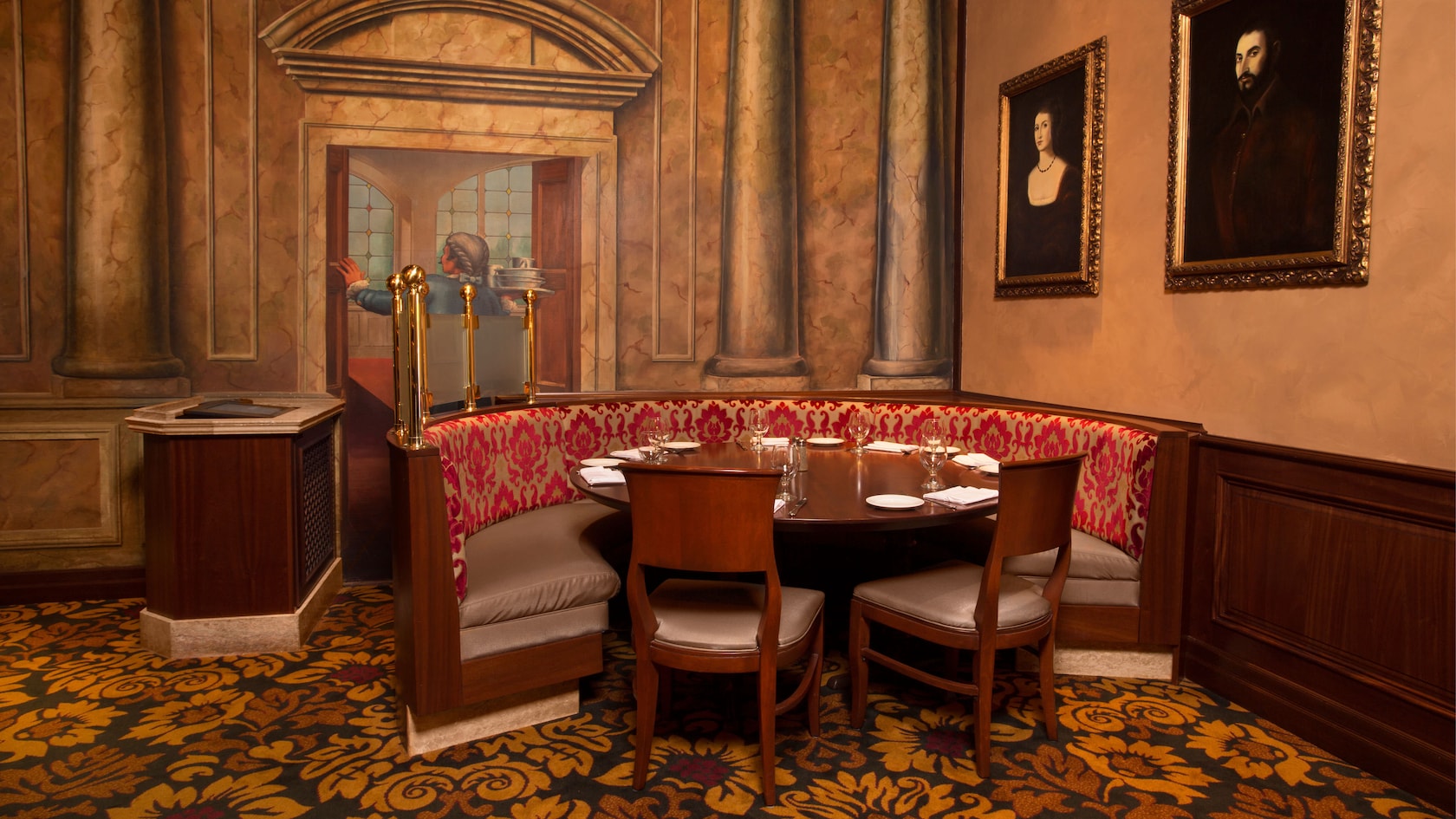 Curved banquette seating in a corner of the main dining area next to a mural