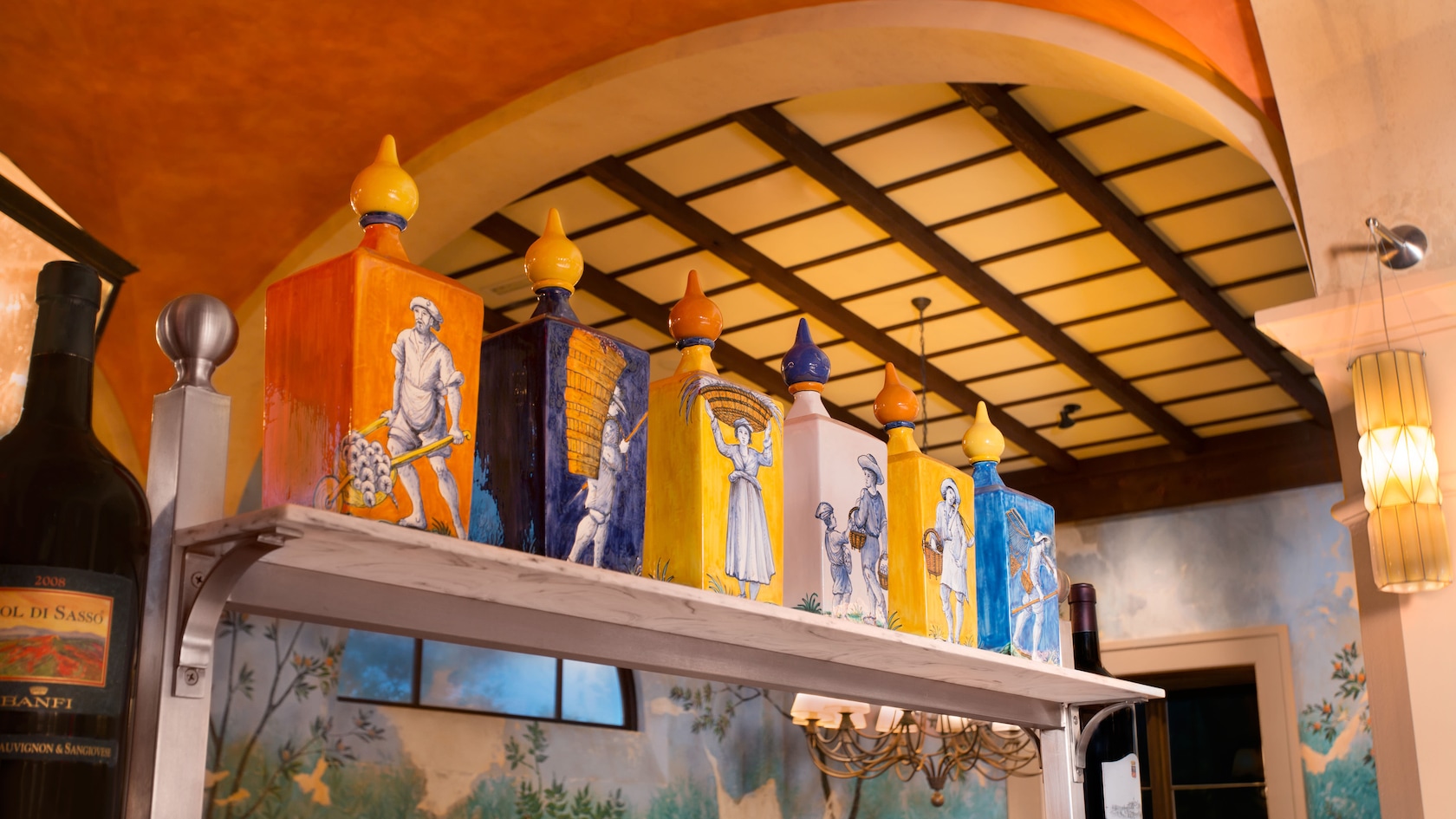 Painted decorative bottles on a high shelf in the dining area