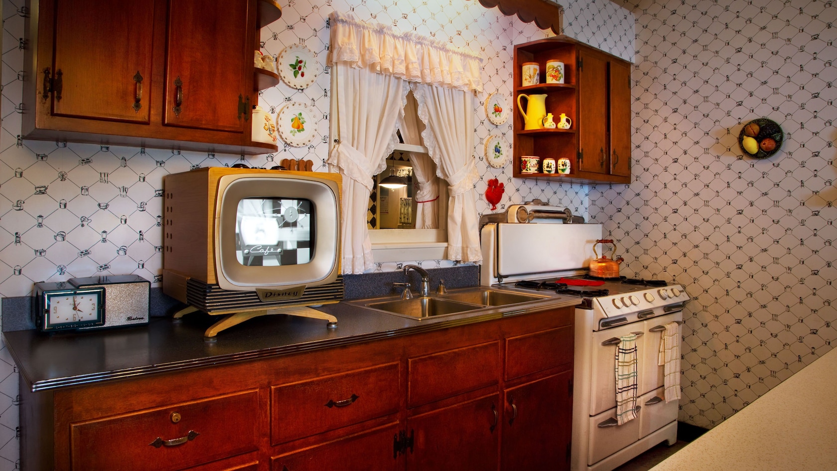 1950s-inspired kitchen with stove, cabinetry, countertop, TV set and 1950's knick-knacks