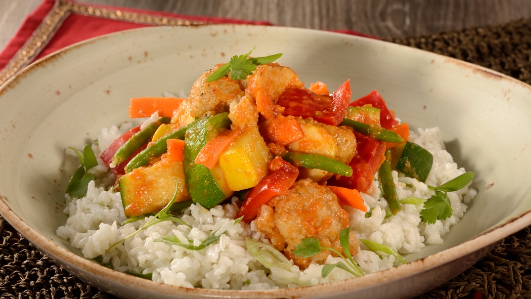 Zucchini, carrots, green beans, bell peppers and cauliflower covered in curry paired with rice