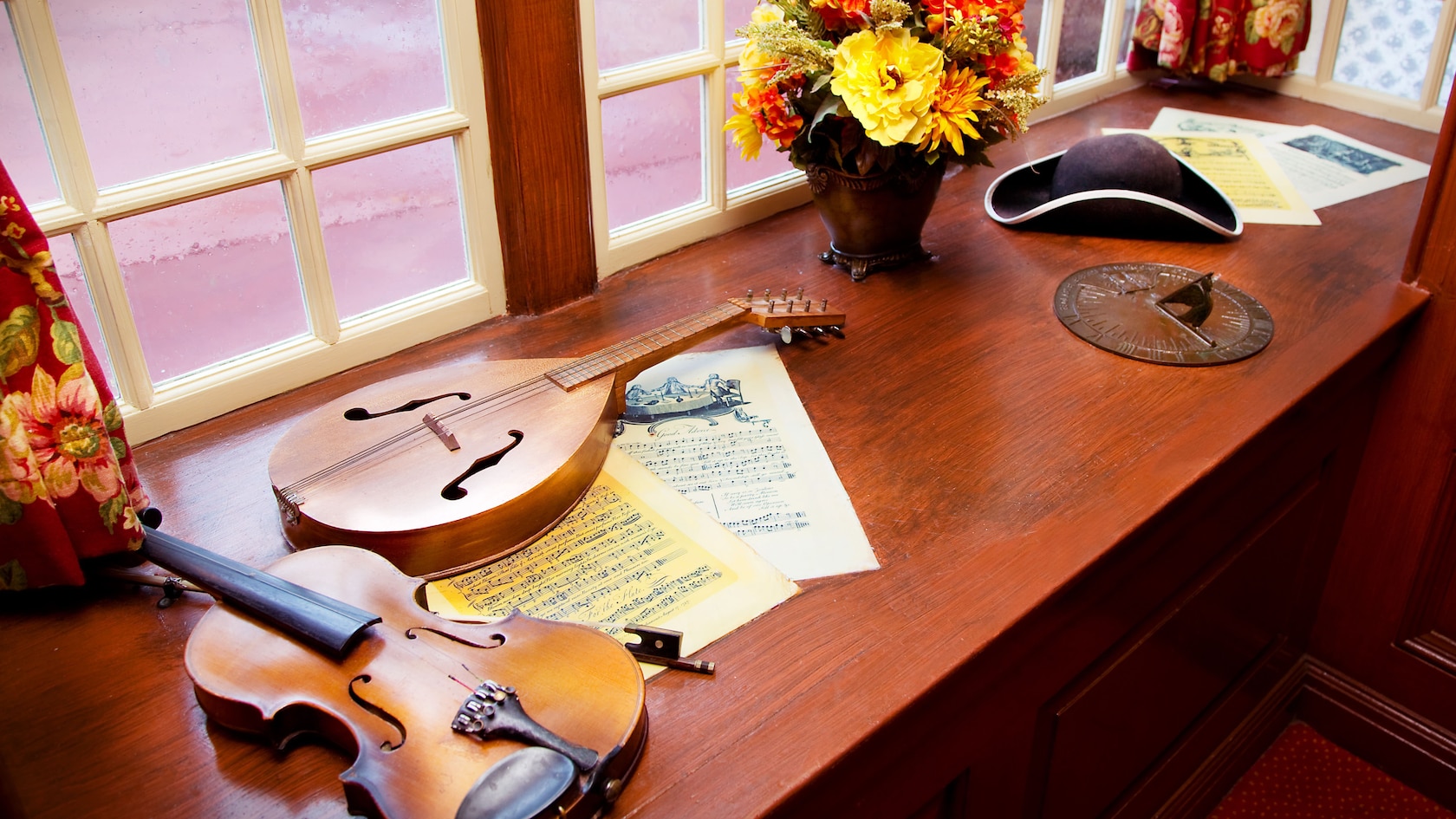 Violin, lute and 18th century artifacts sitting on window seat