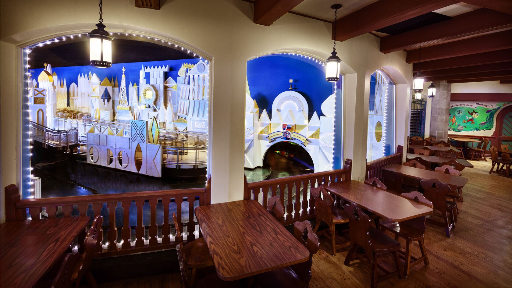 Indoor balcony seating area overlooking 'it's a small world' loading area