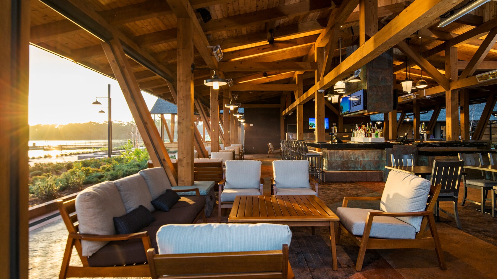 The open air interior of Geyser Point Bar & Grill with a spacious bar area and assorted chair and table setups