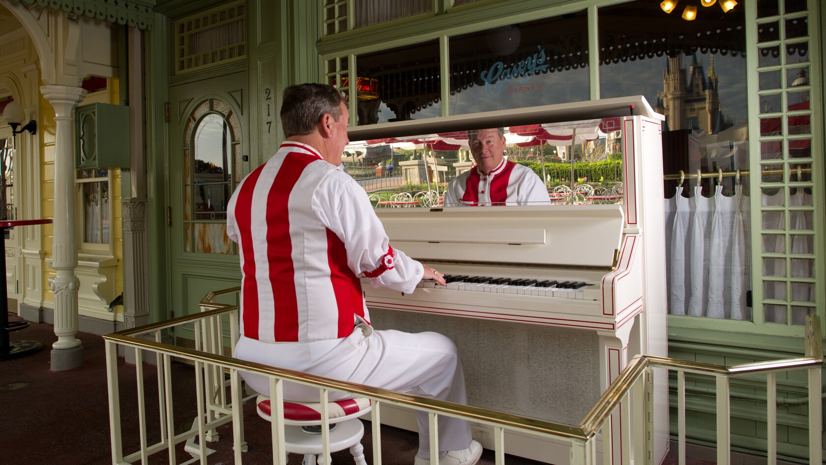 A pianist plays a piano outside Casey's Corner on Main Street, U.S.A.