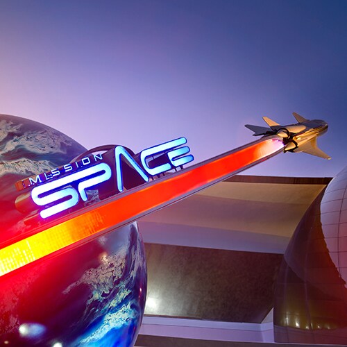 Mission: SPACE sign featuring a rocket ship speeding past Earth outside the attraction at Epcot