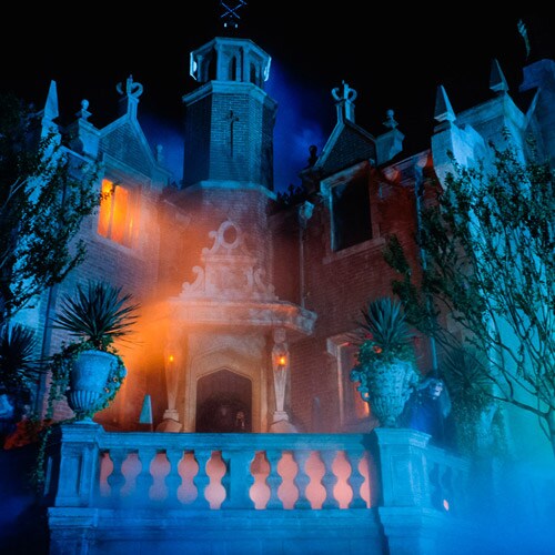 The exterior of the Haunted Mansion surrounded by fog