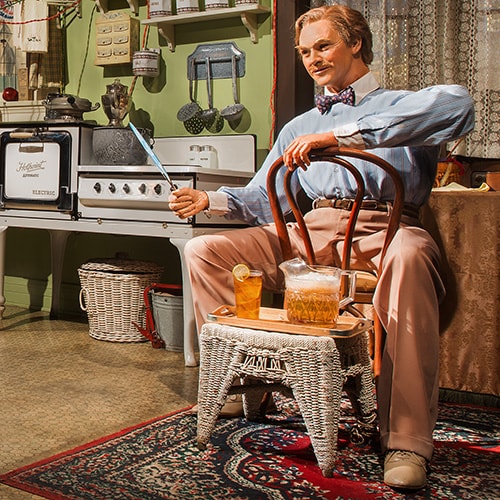 An Audio-Animatronic man sits in a house with the latest conveniences of the 1920s