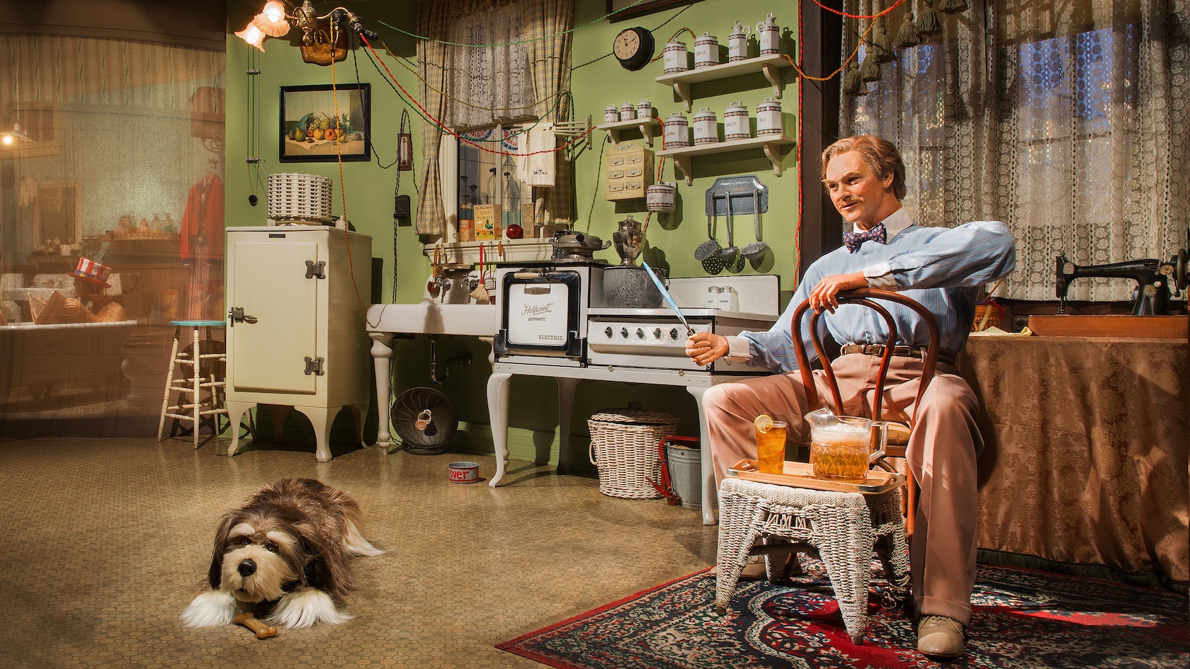 An Audio-Animatronic man and dog sit in a house with the latest conveniences of the 1920s