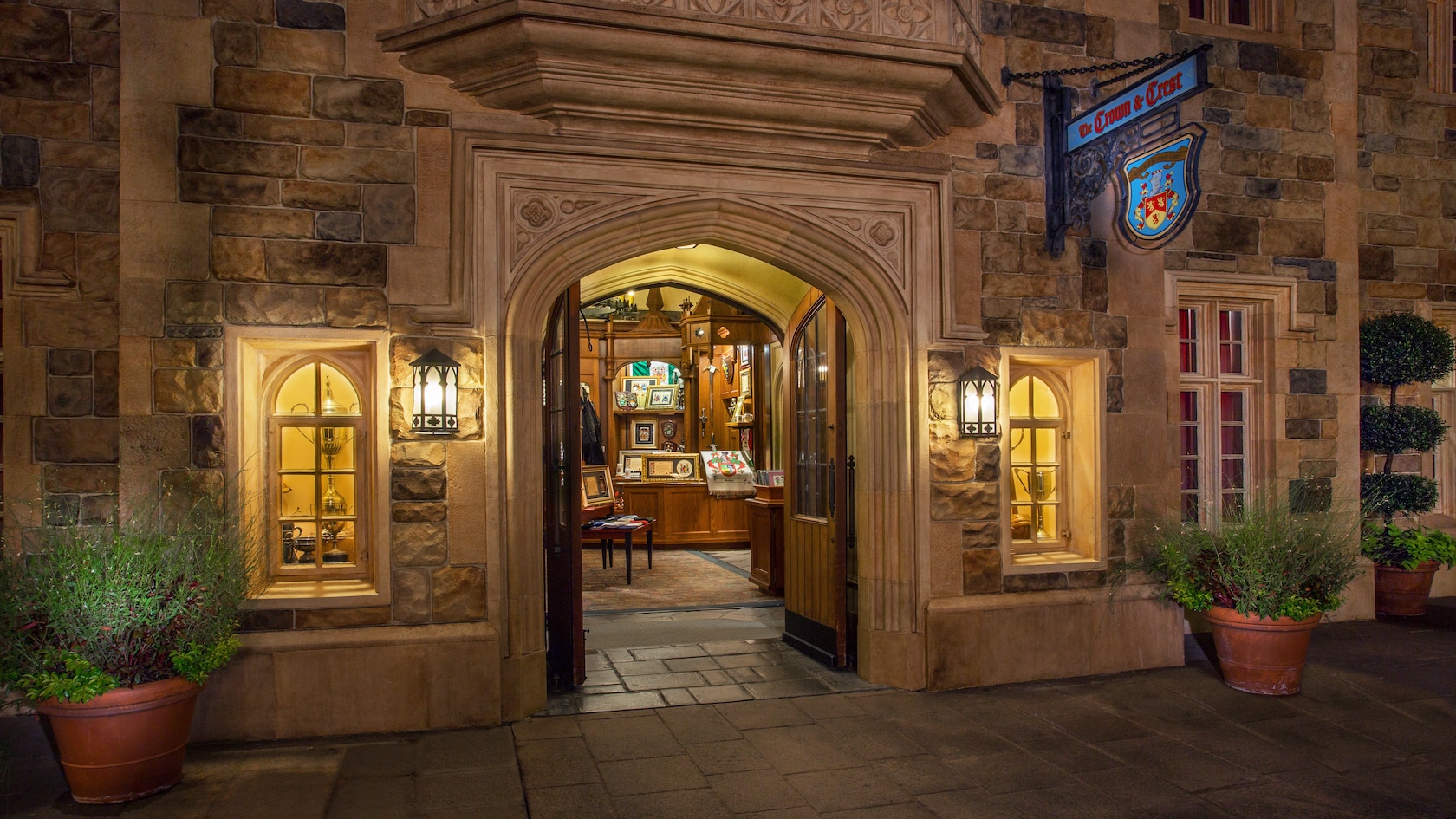 The Crown & Crest shop in the United Kingdom Pavilion at Epcot, lit up at night