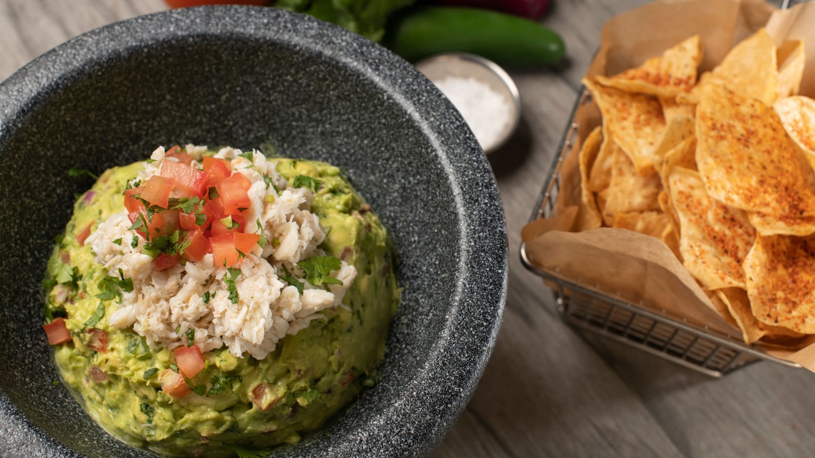 Guacamole de cangrejo en Paddlefish, servido con nachos espolvoreados con Tajín