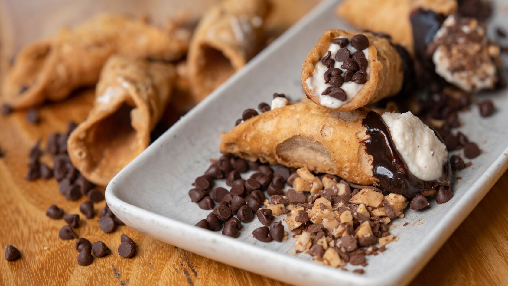 Cannoli served with melted chocolate and chocolate chips 