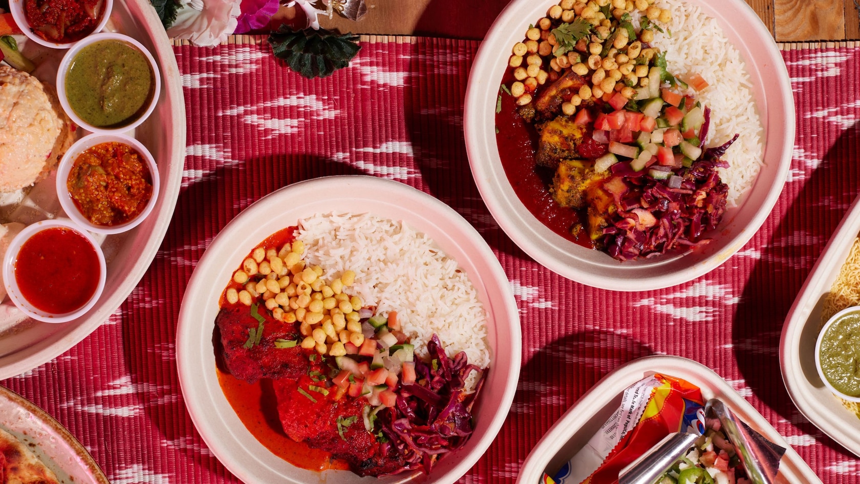 Several round bowls holding dishes made with chickpeas, rice and vegetables