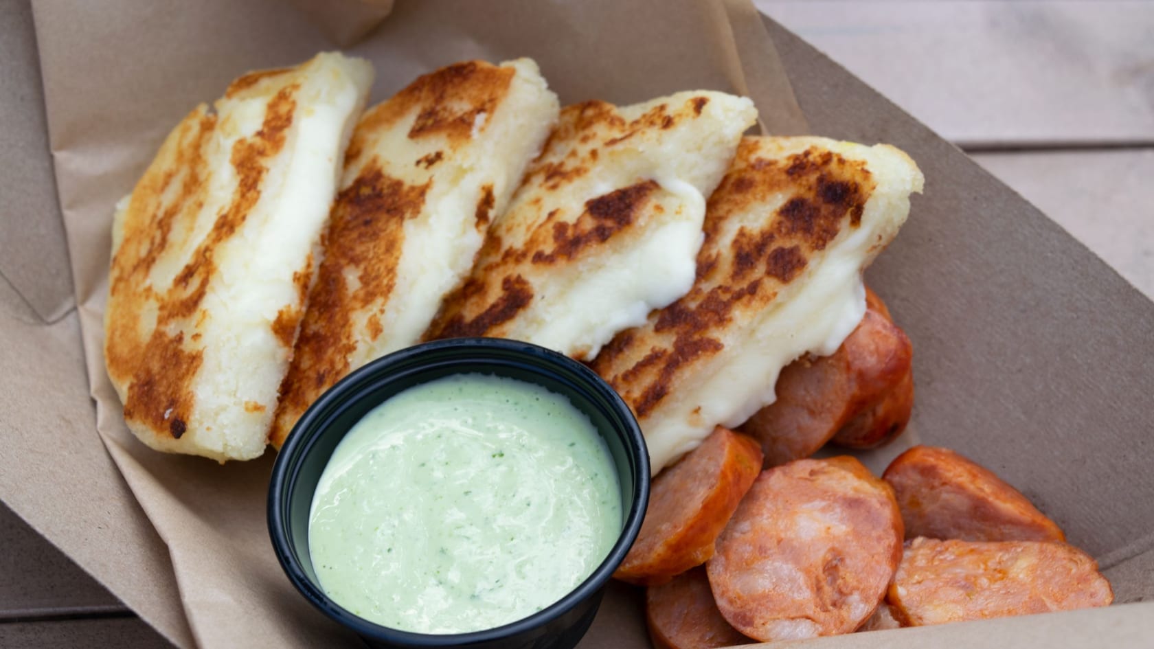 Arepa Encantada served with cilantro avocado mayo dip