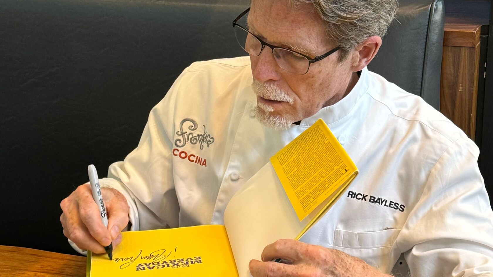 Celebrity chef Rick Bayless signing copies of his book at Frontera Cocina