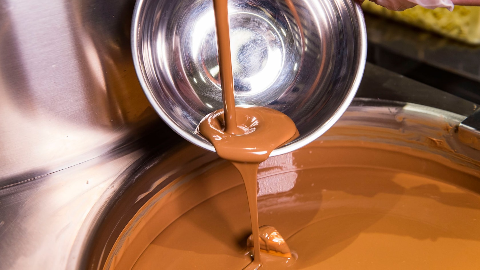 Chocolate sauce being poured into a bowl