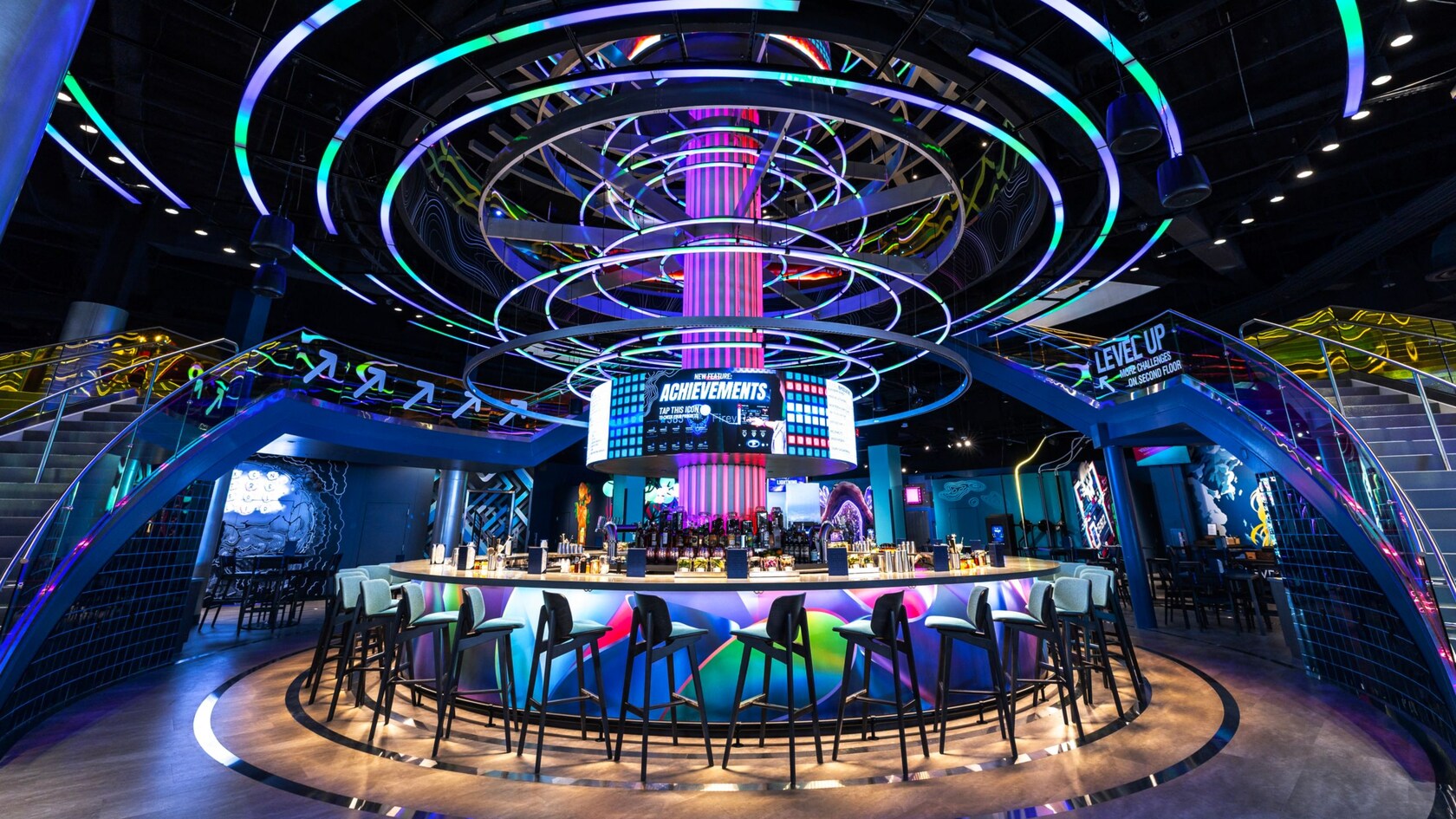 The main bar at Level99 Disney Springs, surrounded by glowing ring lights