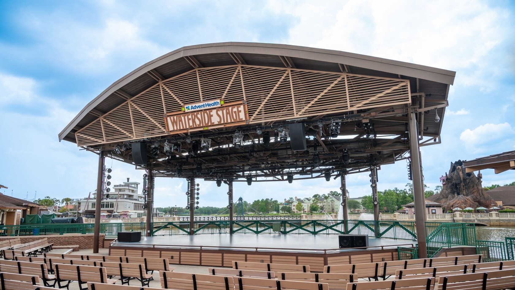 The AdventHealth Waterside Stage at Disney Springs with rows of empty benches