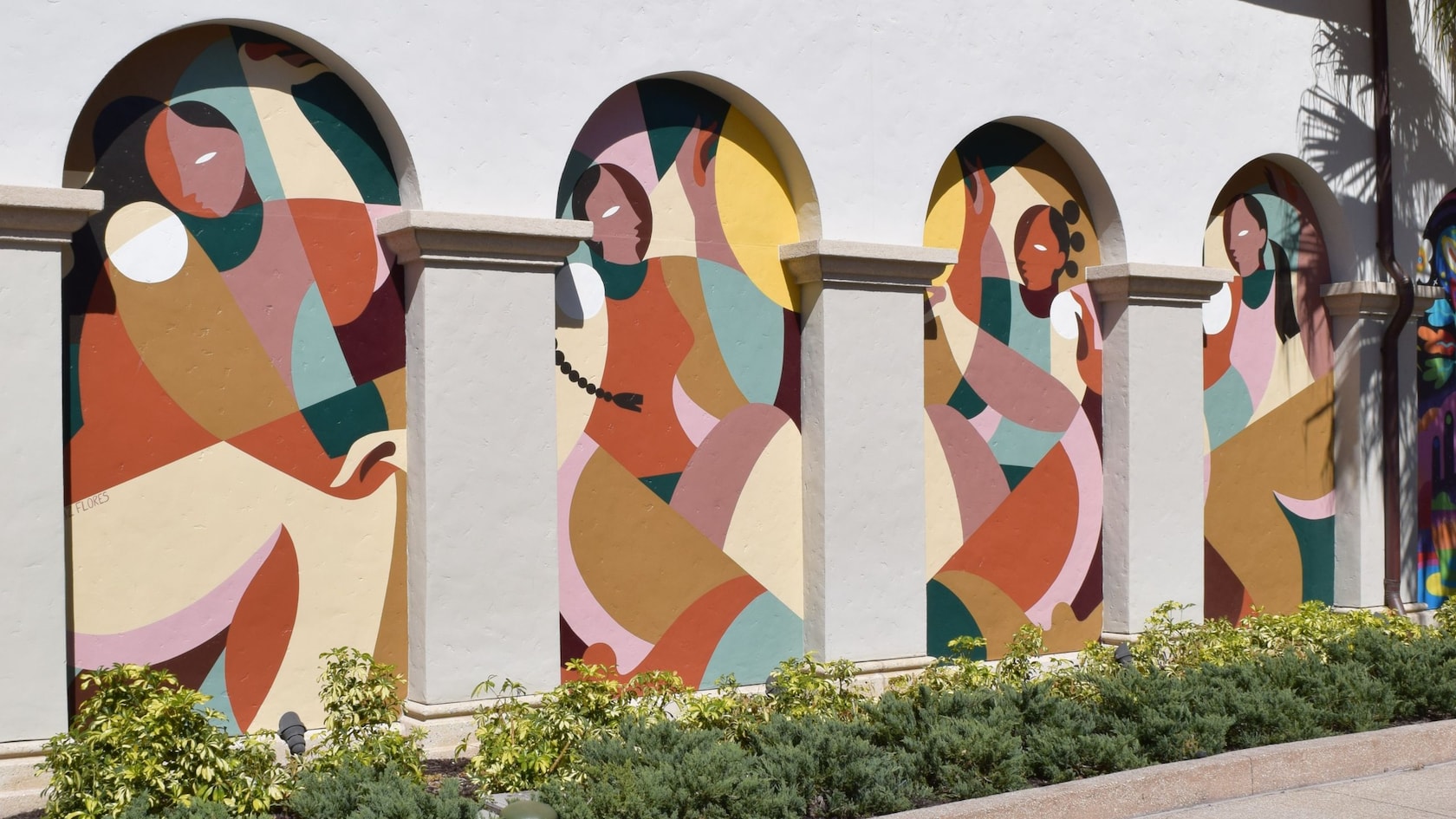 Artist Liz Flores and her mural honoring Women's History Month at Disney Springs Art Walk