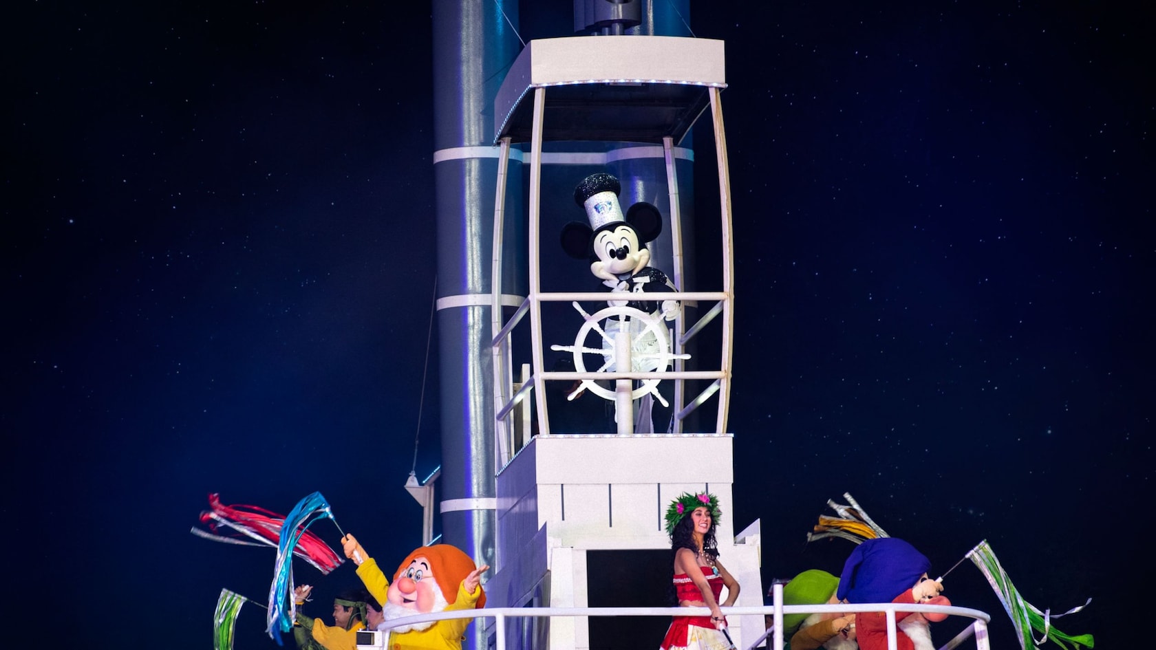 Mickey Mouse steers a steamboat carrying Moana and other Disney Characters