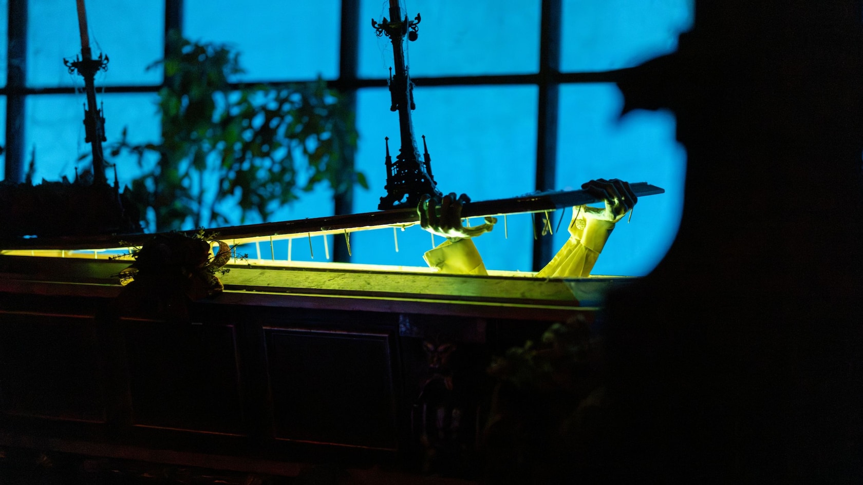 Skeletal hands pushing open the lid of a coffin at the Haunted Mansion in Magic Kingdom park