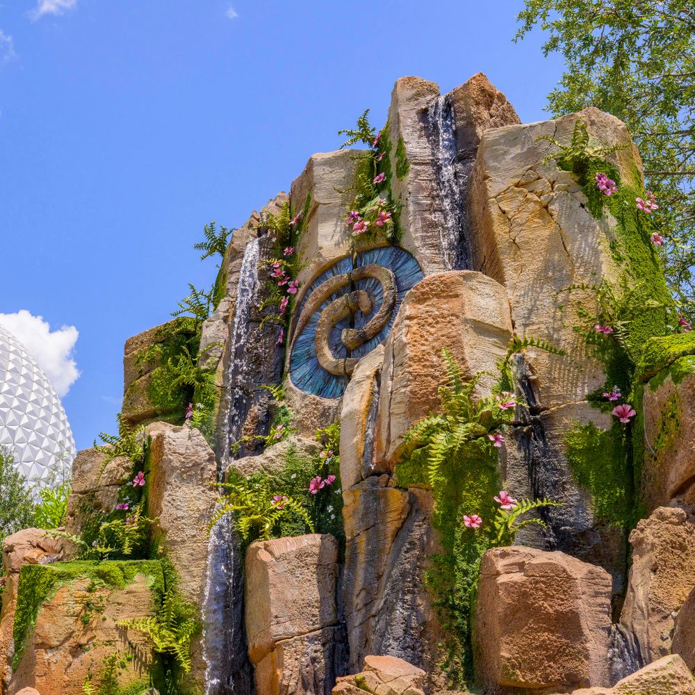 A small waterfall over a rock formation that features the Heart of Te Fiti symbol on the Journey of Water, Inspired by Moana trail
