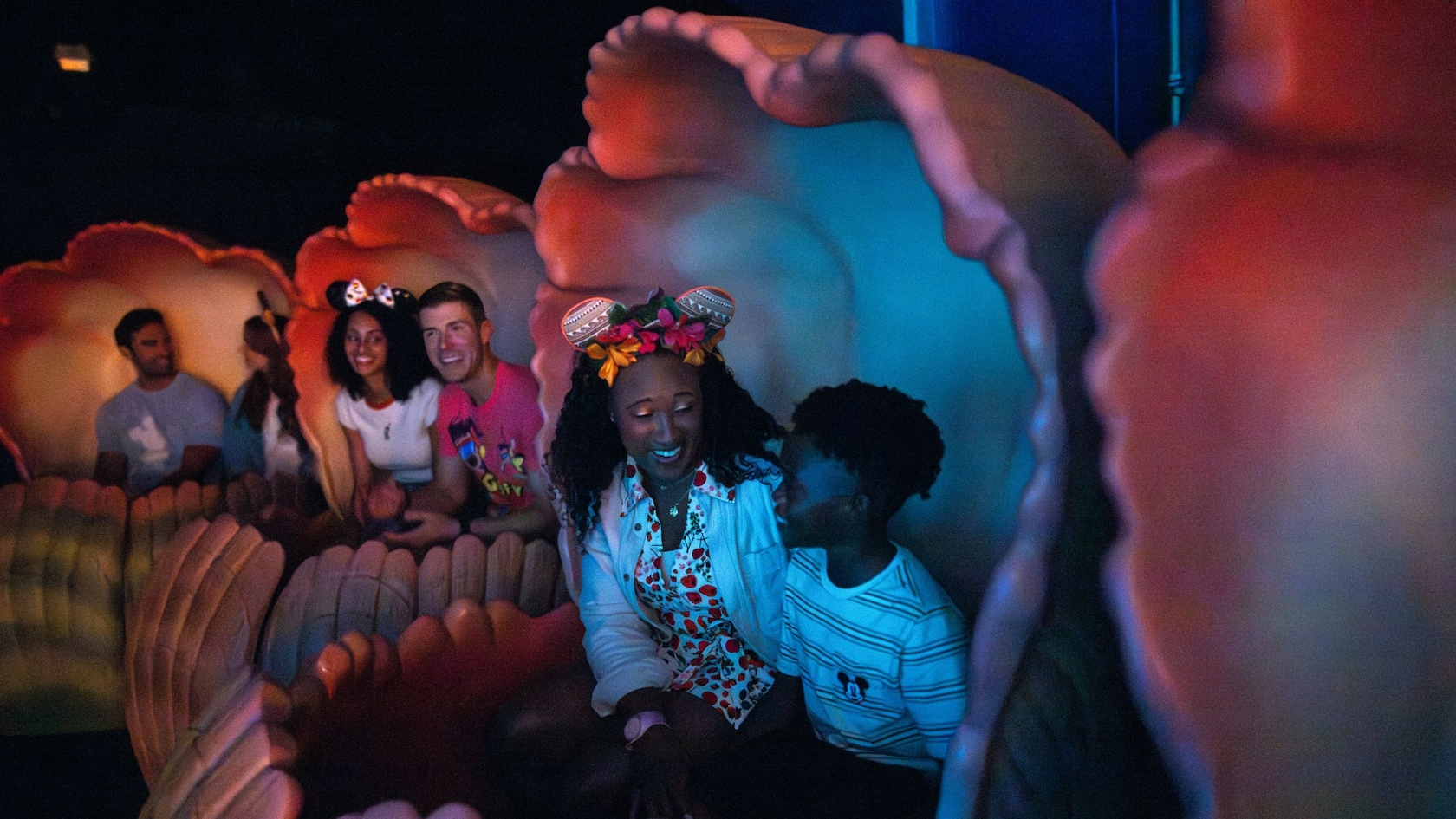 Pairs of Guests riding in seashells at The Seas with Nemo & Friends
