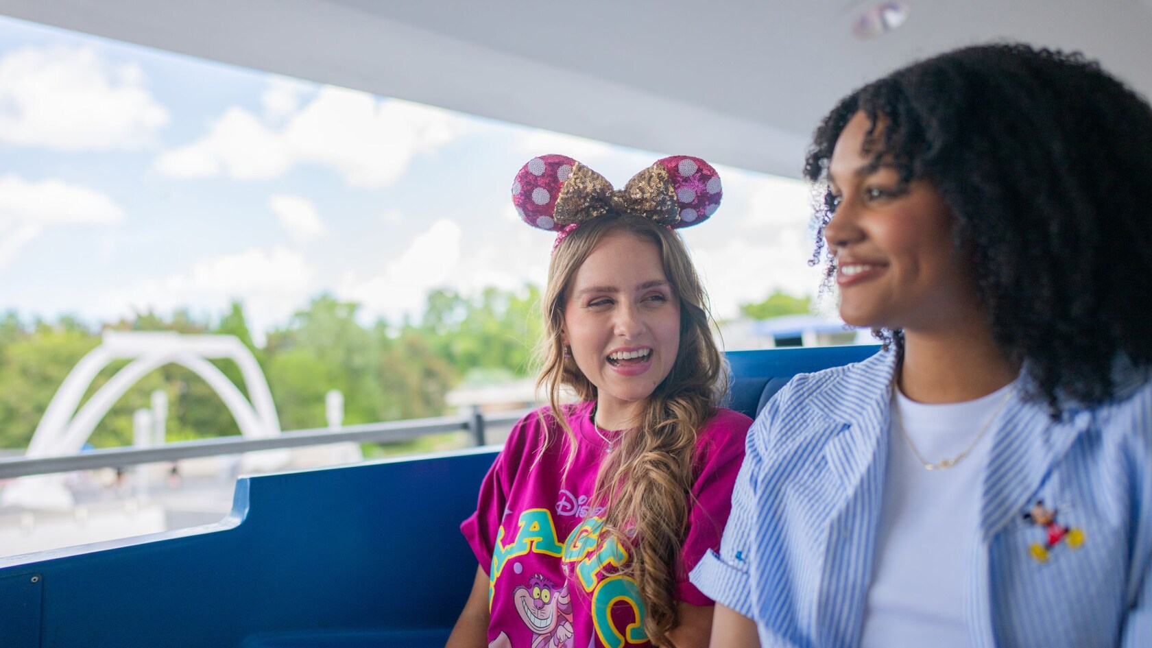 Two Guests riding the Tomorrowland Transit Authority PeopleMover at Magic Kingdom park with views of Cinderella Castle