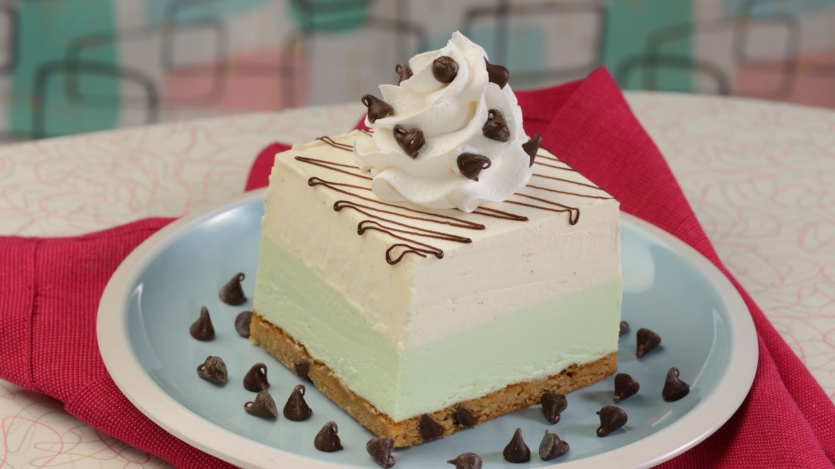 Mint white chocolate mousse and a chocolate chip cookie topped with whipped cream and chocolate chips