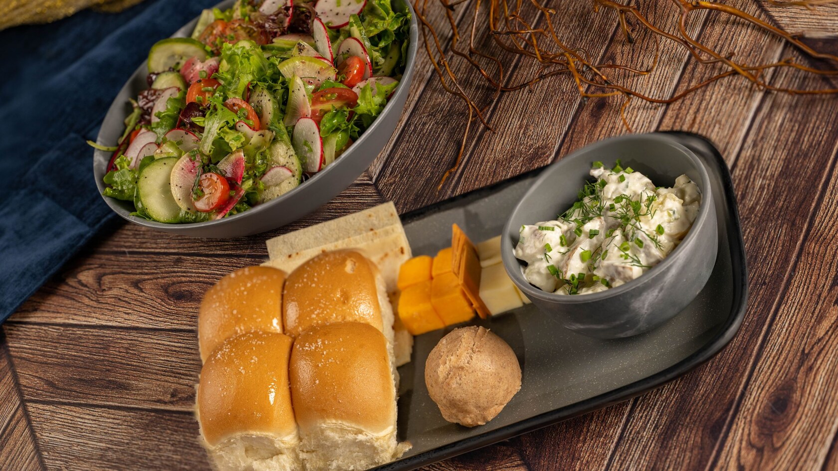 Plant based bread, cinnamon butter, olive oil mashed potatoes, assorted cheeses and a bowl of mixed greens