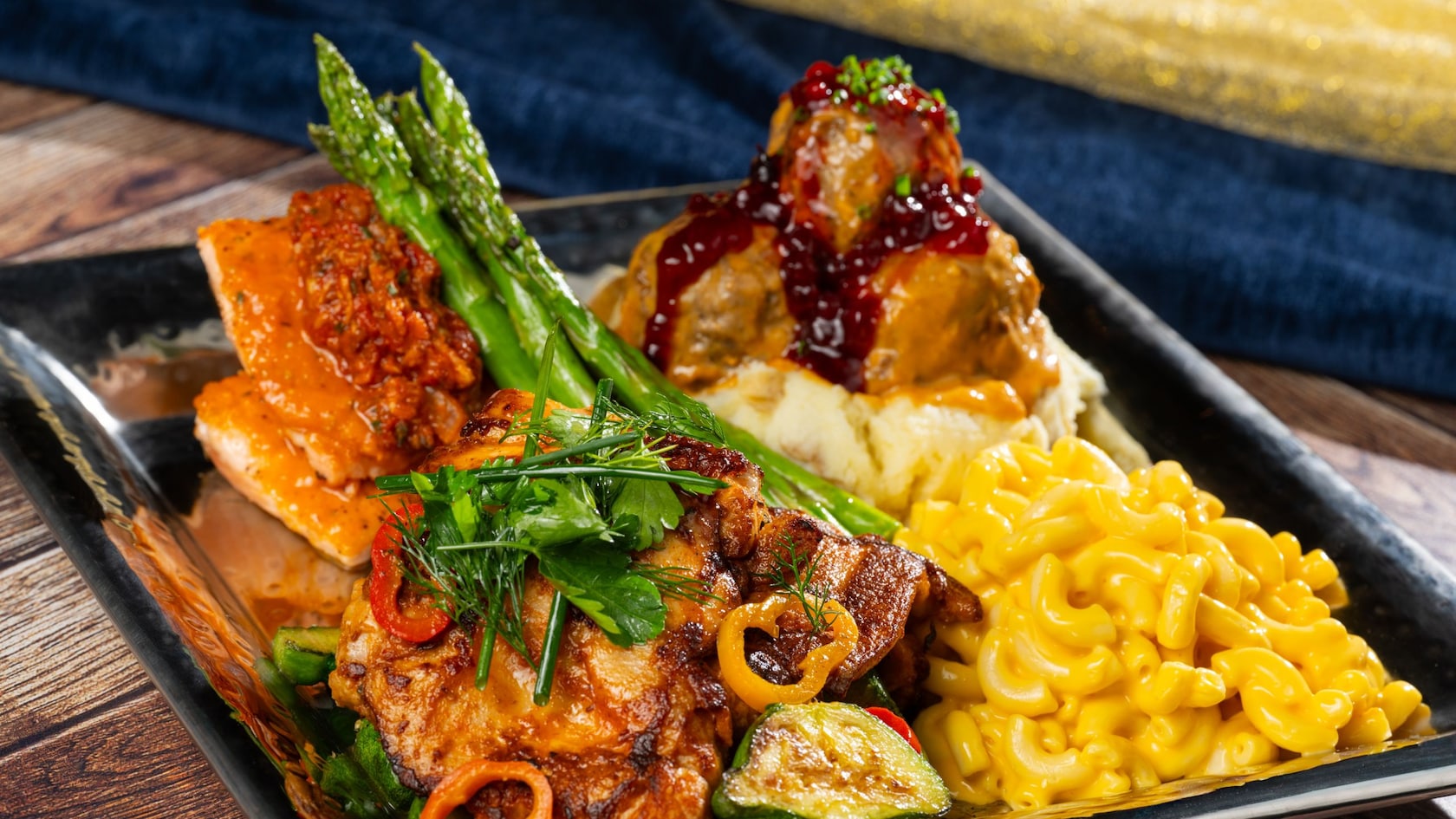 Chicken topped with seasonal vegetables, plated with macaroni and cheese, Nørwegian meatballs with lingonberry jam, mashed potatoes, roasted and grilled salmon from Akershus Royal Banquet Hall