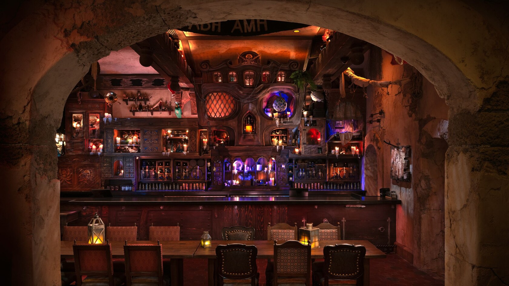 A weathered, arched doorway leads into The Beak and Barrel, a pirate themed tavern at Magic Kingdom park