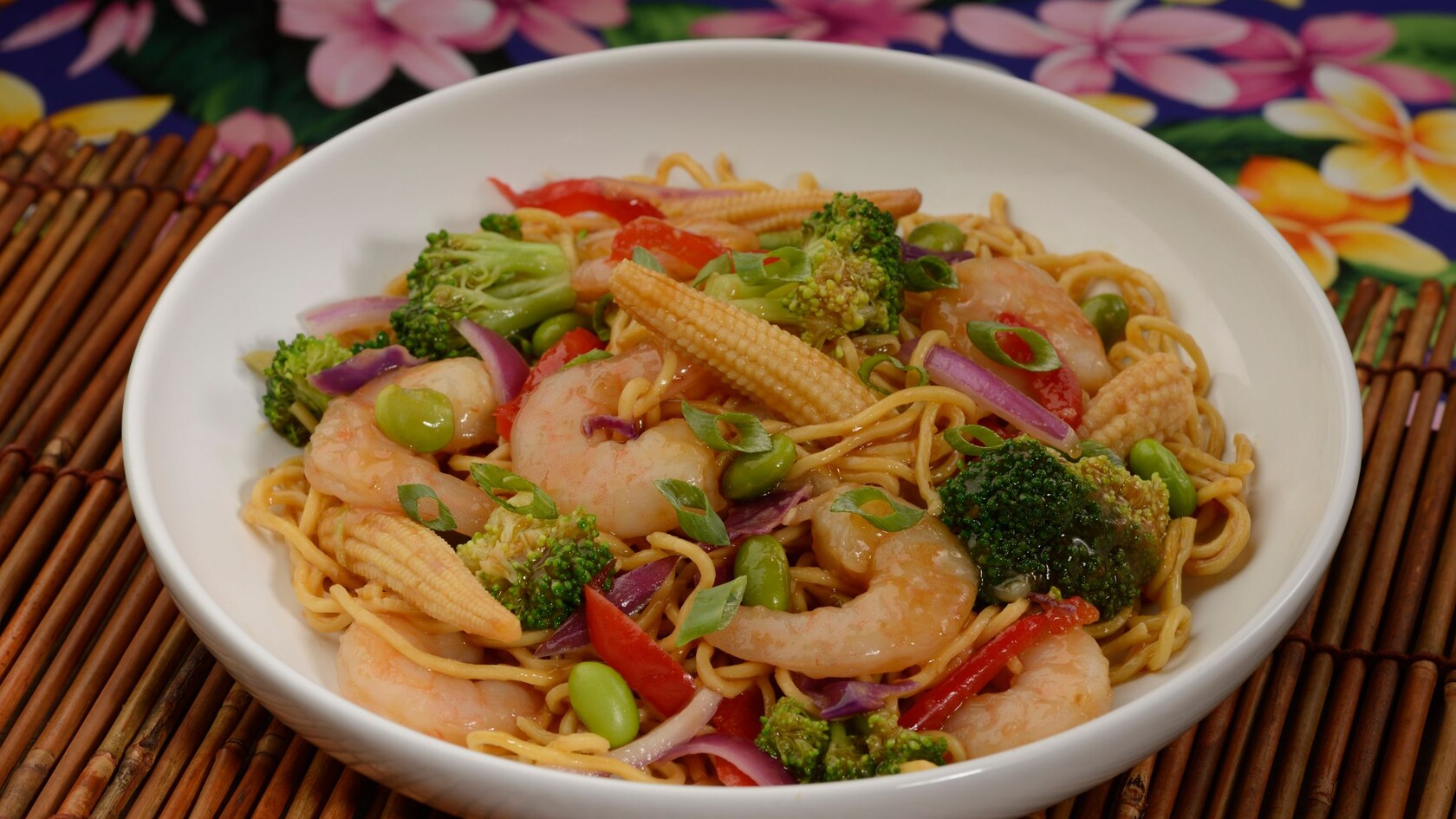 A bowl of stir fry made with shrimp, broccoli and other veggies