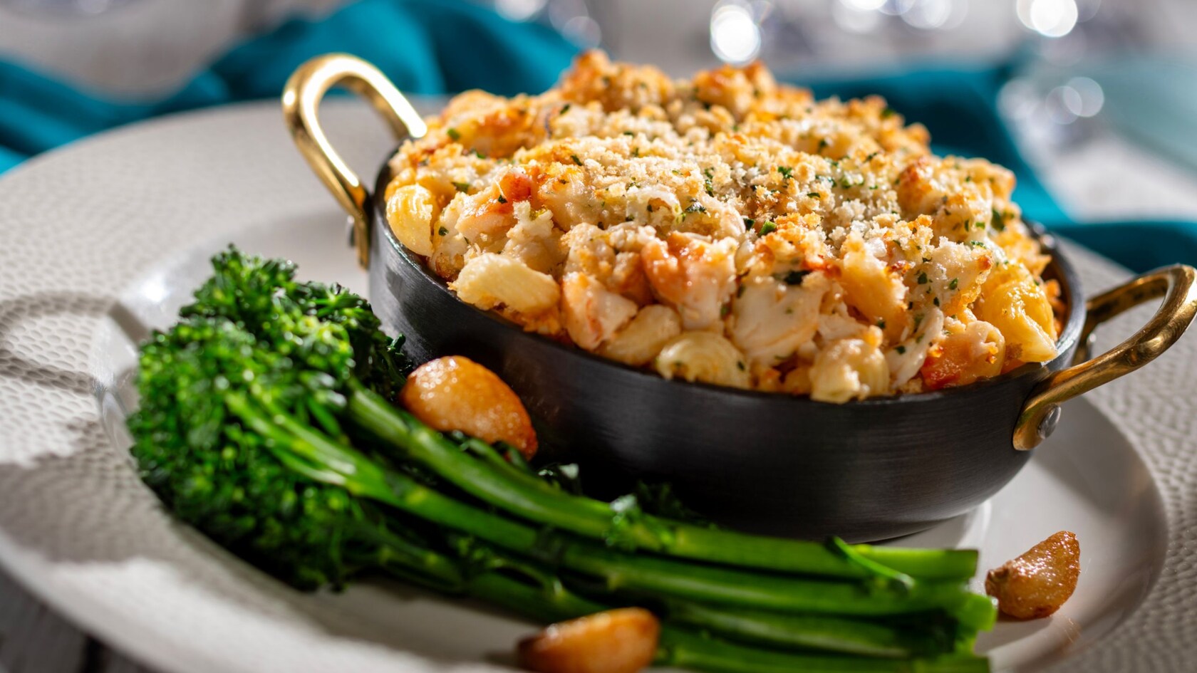 A small pot of macaroni and cheese served with broccoli and roasted garlic, from Coral Reef Restaurant at Epcot