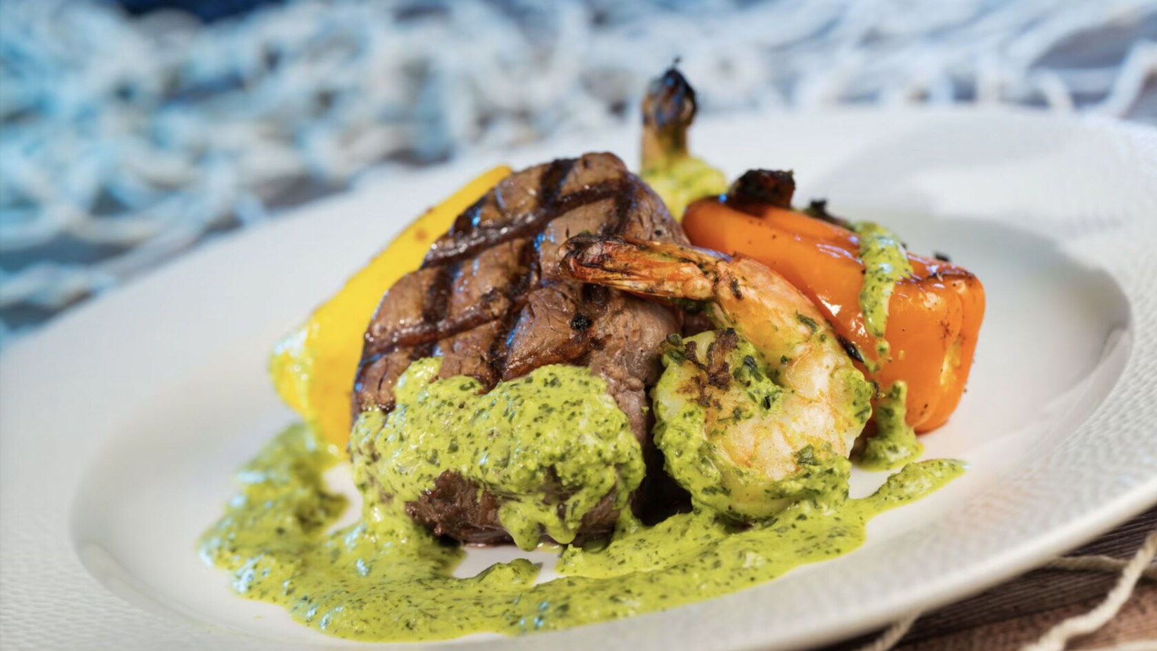 Grilled steak and shrimp with green sauce and vegetables, from Coral Reef Restaurant at Epcot