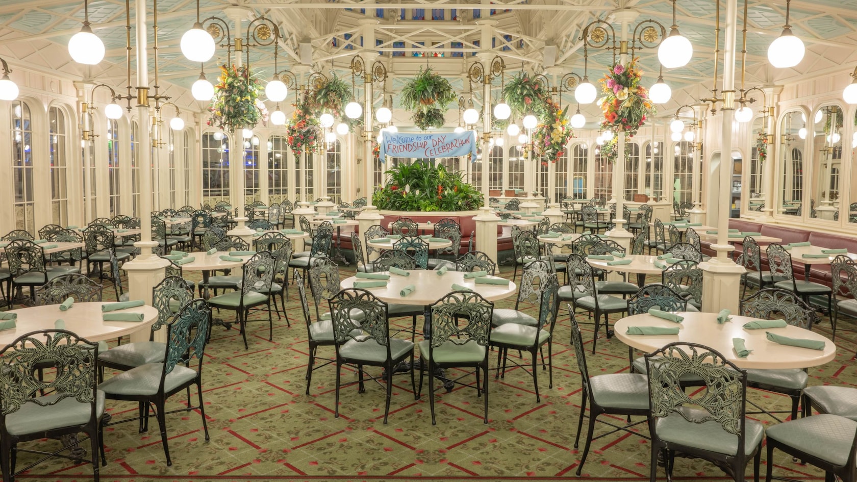 The Victorian greenhouse inspired dining room of The Crystal Palace at Magic Kingdom park