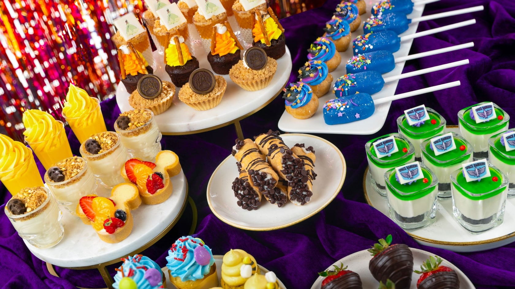 A platter of desserts including brownies, parfaits, crumble cups, cake pops, profiteroles, cannoli, cupcakes and chocolate dipped strawberries