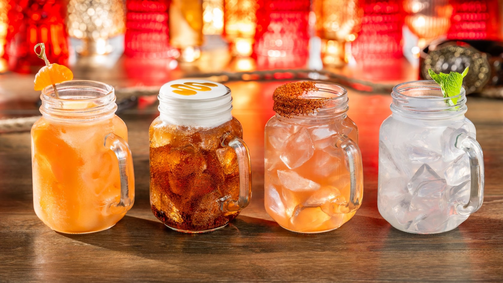 An assortment of 4 cocktails in glass mugs from Diamond Horseshoe Lounge at Magic Kingdom park