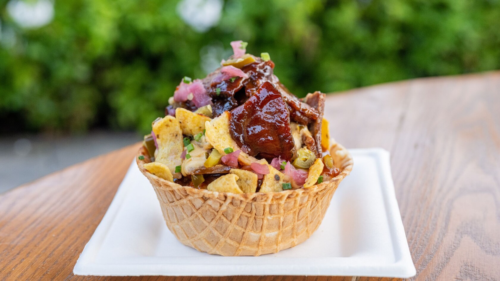 Poitrine de bœuf au barbecue, piment jalapeno mariné, oignon rouge et croustilles de maïs, le tout servi dans un bol en gaufre